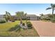 Charming home with brick accents, a well-maintained lawn, and a brick paver driveway at 1405 W Del Webb Blvd, Sun City Center, FL 33573