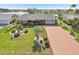 Well-maintained home with lush landscaping, brick accents, and a long driveway at 1405 W Del Webb Blvd, Sun City Center, FL 33573
