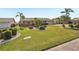 Well-maintained home featuring a brick-accented facade, lush landscaping, and a manicured front lawn at 1405 W Del Webb Blvd, Sun City Center, FL 33573