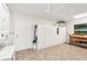 Spacious garage featuring tile flooring, storage cabinets, washer and dryer hookups, and a convenient work bench at 1405 W Del Webb Blvd, Sun City Center, FL 33573