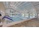 Bright indoor pool area with lane markers, high ceilings, and ample natural light at 1405 W Del Webb Blvd, Sun City Center, FL 33573