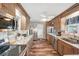 Spacious kitchen featuring stainless steel appliances, granite countertops, and wood cabinets at 1405 W Del Webb Blvd, Sun City Center, FL 33573