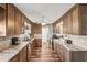 Well-appointed kitchen with rich wood cabinets, granite countertops, and modern stainless steel appliances at 1405 W Del Webb Blvd, Sun City Center, FL 33573