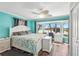 Bright main bedroom with bay window, ceiling fan, and wood floors at 1405 W Del Webb Blvd, Sun City Center, FL 33573