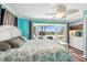 Bright main bedroom with bay window overlooking the canal, ceiling fan, and wood floors at 1405 W Del Webb Blvd, Sun City Center, FL 33573