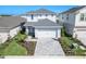 Attractive two-story home with gray tones, well-kept lawn, paved driveway, and an attached garage at 15918 Mulrion Blvd, Punta Gorda, FL 33982