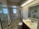 Bathroom featuring a glass-enclosed shower, vanity with sink, and updated fixtures at 1654 S Lake Ave # 2, Clearwater, FL 33756