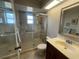 Bathroom featuring a glass-enclosed shower, vanity with sink, and updated fixtures at 1654 S Lake Ave # 2, Clearwater, FL 33756