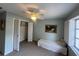 Bedroom with a ceiling fan and closet, light green walls, and a window with shutters at 1654 S Lake Ave # 2, Clearwater, FL 33756