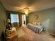 Cozy bedroom with soft lighting, connected to a full bathroom, creating a relaxing retreat at 1654 S Lake Ave # 2, Clearwater, FL 33756