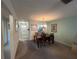 Dining area featuring carpeted floors adjacent to the kitchen and the home's entry at 1654 S Lake Ave # 2, Clearwater, FL 33756