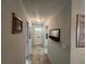 Hallway with light tile flooring, leading to the front door and other rooms at 1654 S Lake Ave # 2, Clearwater, FL 33756