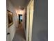 Hallway with carpet flooring, neutral paint and white doors at 1654 S Lake Ave # 2, Clearwater, FL 33756