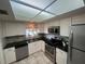 Bright kitchen with white cabinets, stainless steel appliances, and dark countertops offers lots of room at 1654 S Lake Ave # 2, Clearwater, FL 33756
