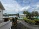 Scenic view of the lake from landscaped backyard with a brick pathway and seating area at 1654 S Lake Ave # 2, Clearwater, FL 33756