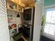 Laundry closet with stacked washer and dryer and built-in shelving, offering functionality at 1654 S Lake Ave # 2, Clearwater, FL 33756