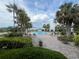 Community pool area lined with palm trees and ample lounge chairs at 1654 S Lake Ave # 2, Clearwater, FL 33756