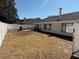 Backyard featuring a white fence, patio area with outdoor furniture, and well-kept lawn at 1710 Tallowtree Cir, Valrico, FL 33594