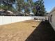 Large backyard with a white privacy fence, featuring a grill and outdoor seating at 1710 Tallowtree Cir, Valrico, FL 33594