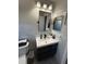 Modern bathroom features updated sink, toilet, and large mirror at 1710 Tallowtree Cir, Valrico, FL 33594