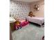 The bedroom has pink walls and a closet with stuffed animals at 1710 Tallowtree Cir, Valrico, FL 33594