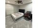 This bedroom features a ceiling fan, a large window and desk at 1710 Tallowtree Cir, Valrico, FL 33594