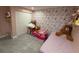 The bedroom has pink walls and a closet with stuffed animals at 1710 Tallowtree Cir, Valrico, FL 33594