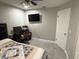 This bedroom features a ceiling fan, a large window and desk at 1710 Tallowtree Cir, Valrico, FL 33594
