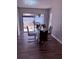 Bright dining room features a modern glass table, stylish chairs, and natural light from the sliding glass door at 1710 Tallowtree Cir, Valrico, FL 33594