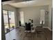 Bright dining room features a modern glass table, stylish chairs, and natural light from the sliding glass door at 1710 Tallowtree Cir, Valrico, FL 33594
