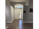 Inviting entryway with wood-look floors, high ceilings, and plenty of natural light at 1710 Tallowtree Cir, Valrico, FL 33594