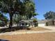 Single-story home with mature landscaping, a two-car garage, and a walkway leading to the front door at 1710 Tallowtree Cir, Valrico, FL 33594