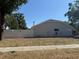 The exterior features a white fence enclosing the property and a neatly maintained lawn at 1710 Tallowtree Cir, Valrico, FL 33594