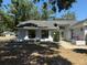 Home exterior with a well-manicured lawn and landscaped garden beds along the entryway at 1710 Tallowtree Cir, Valrico, FL 33594