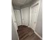Hallway with multiple white doors and laminate flooring at 1710 Tallowtree Cir, Valrico, FL 33594