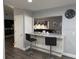 Eat-in kitchen bar with stylish stools and marble countertops at 1710 Tallowtree Cir, Valrico, FL 33594