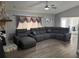 Comfortable living room with wood-look flooring, stone fireplace, and sectional couch at 1710 Tallowtree Cir, Valrico, FL 33594