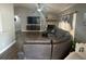 Spacious living room featuring wood-look flooring, a stone fireplace, and a comfy sectional sofa at 1710 Tallowtree Cir, Valrico, FL 33594