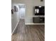 Open living room with wood flooring and updated media center at 1710 Tallowtree Cir, Valrico, FL 33594