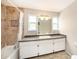 Bathroom featuring tiled shower and tub, along with updated vanity and countertop at 1719 Bayhill Dr, Oldsmar, FL 34677