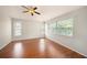 Bedroom features wood floors, multiple windows, and a ceiling fan at 1719 Bayhill Dr, Oldsmar, FL 34677
