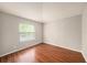 Spare bedroom with wood floors, large window, and neutral paint at 1719 Bayhill Dr, Oldsmar, FL 34677