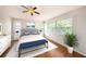 Bright bedroom with hardwood floors, ceiling fan, neutral walls, and comfortable furnishings at 1719 Bayhill Dr, Oldsmar, FL 34677