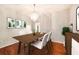 Elegant dining room featuring hardwood floors, a modern chandelier, and tasteful decor for sophisticated entertaining at 1719 Bayhill Dr, Oldsmar, FL 34677