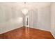 Minimalist dining room with hardwood flooring, a modern chandelier, and ample space for dining and entertaining at 1719 Bayhill Dr, Oldsmar, FL 34677