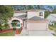 Charming two-story home featuring a two-car garage, well-maintained landscaping, and a welcoming entrance at 1719 Bayhill Dr, Oldsmar, FL 34677