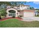Charming two-story home featuring a two-car garage, well-maintained landscaping, and a welcoming entrance at 1719 Bayhill Dr, Oldsmar, FL 34677