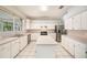 Spacious kitchen with island, stainless steel appliances, tile floors, and ample cabinet space at 1719 Bayhill Dr, Oldsmar, FL 34677