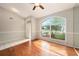 Bright living room featuring wood floors, large windows, and a mirrored wall reflecting the natural light at 1719 Bayhill Dr, Oldsmar, FL 34677