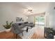 Inviting living room features an oversized sectional couch, neutral decor, and sliding glass doors to the pool area at 1719 Bayhill Dr, Oldsmar, FL 34677